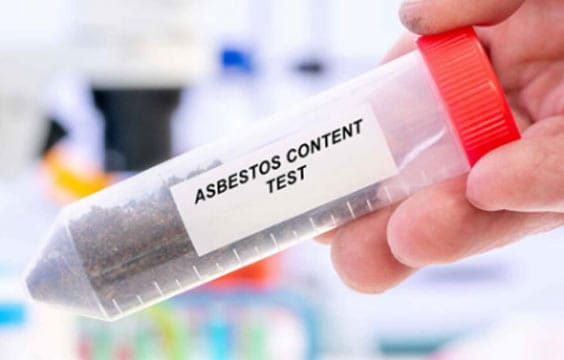 Asbestos Content Test Sample Container Hand holding a test container labeled 'Asbestos Content Test' filled with dark material.