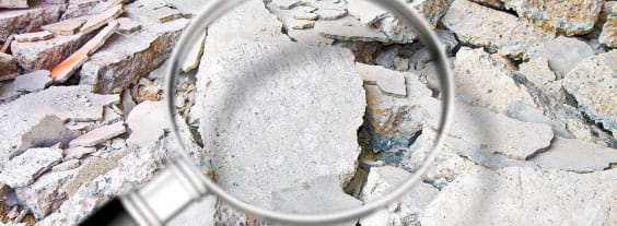 Asbestos Material with Magnifying Glass Close-up view of asbestos material with a magnifying glass highlighting its texture and layers.